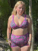 women wearing a pink and emerald green triangle bikini top for surfing that has thick supportive straps and pink and emerald green surf swim shorts that are high waisted